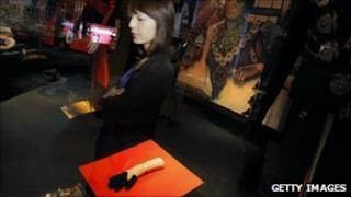 A woman surveys Michael Jackson memorabilia at the Hollywood Legends auction