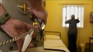 Guard locking prison cell