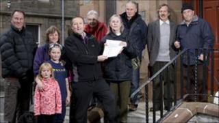 Phyllis Goodall hands over the letters of support to David Rodger of Vattenfall