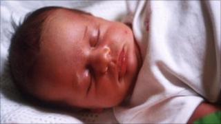 Baby in cot