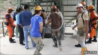 Rescuers and miners prepare to go down the a shaft at the Casa Negra mine
