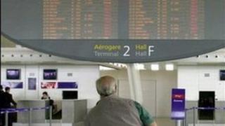 Man Looks at Electronic Flight board