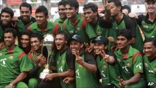 The triumphant Bangladeshis pose with their trophy in Dhaka on 17 October 2010