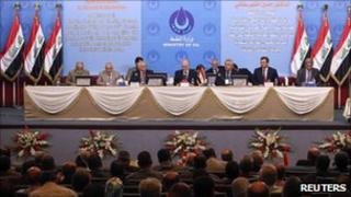 Iraqi oil officials attend the bidding in Baghdad