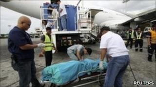 Medics remove the body of the man found dead in the plane's toilet