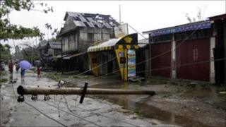 A road blocked by a fallen telephone pole after Cyclone Giri swept through Kyaukphyu
