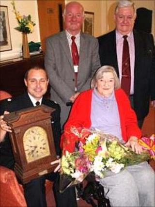 Bettie Lewis hands over the clock