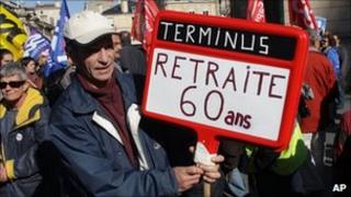 A protester in Bordeaux holds a placard reading: "Terminus: Retirement at 60" (20 Oct 2010)