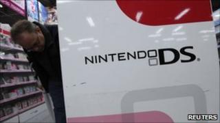 Man looking at Nintendo products in a store in Tokyo