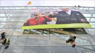 Greenpeace activists unfurl a protest banner on the Christian Democrat HQ in Berlin, 28 October