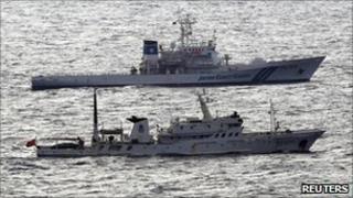 A Japanese coast guard vessel (top) and a Chinese fisheries patrol vessel near near the disputed islands in the East China Sea, known as the Senkaku isles in Japan, Diaoyu in China - 28 September 2010