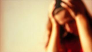 Woman with head in hands