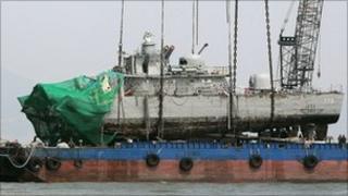 Cheonan being placed on a barge after a giant crane lifted it from the seabed (15 April)