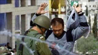 Palestinian searched by Israeli soldier (file)