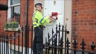 Police leafletting residents during the drugs raids