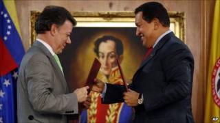 Colombian President Juan Manuel Santos (left) and Venezuelan President Hugo Chavez exchange bilateral agreements at Miraflores presidential palace in Caracas, Venezuela on 2 November, 2010