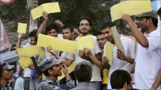 Youths belonging to a self proclaimed non-political group hold up yellow cards at Constituent Assembly members, outside the Parliament House in Kathmandu, September 26, 2010, saying they should be penalized for a foul for not being able to elect a new Prime Minister.