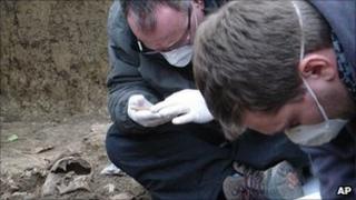 Researchers at site of mass grave