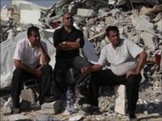 Israeli Arabs near the rubble of a mosque demolished by Israeli police in the Bedouin city of Rahat, southern Israel, 7 November