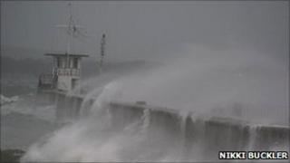 Waves top the breakwater at Mountbatten in Plymouth