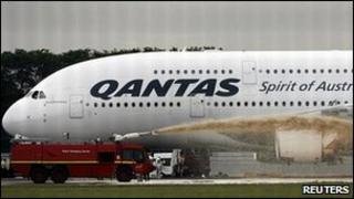 Qantas Airways 380 passenger plane flight QF32 is sprayed by rescue services after making an emergency landing at Changi airport in Singapore November 4, 2010