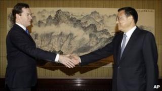George Osborne, left, shakes hands with China's Vice Premier Li Keqiang