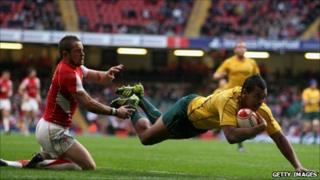 Wallabies full back Kurtley Beale beats Shane Williams to score during the Test match between Wales and Australia