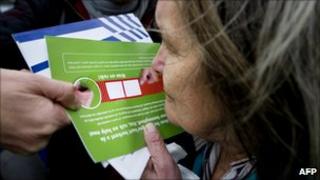 A woman smells a marijuana-scented card in Rotterdam on 8 November 2010