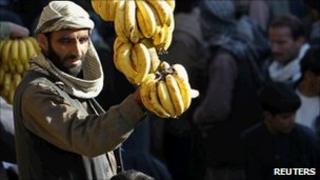 A man shows bananas for sale at a market in Kabul on 8 November 2010