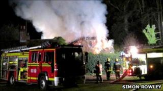 Crews at the scene of the cottage on fire