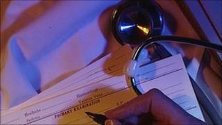 GP filling out medical form