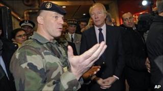 French Interior Minister Brice Hortefeux listens as a soldier speaks at Montparnasse railway station in Paris, 10 November
