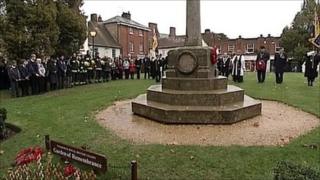 People standing at war memorial in Wimborne