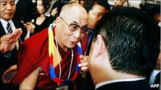 Tibetan spiritual leader Dalai Lama shakes hands with Chinese activist Wu'er Kaixi