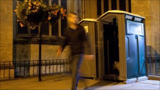 Man leaving portable toilet