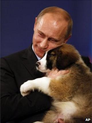Russian Prime Minister Vladimir Putin cuddles a Bulgarian sheepdog