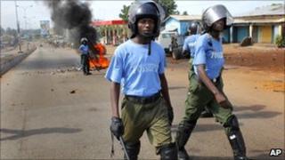 Guinean police face off supporters of UFDG presidential candidate Cellou Dalein Diallo in the streets of Conakry, Guinea, Monday, Nov. 15, 2010