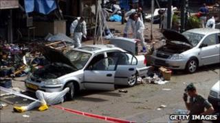 Forensic teams examine the scene of a suicide bomb attack in Tel Aviv