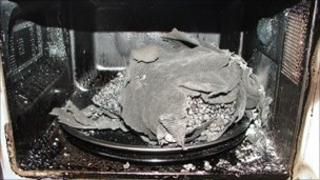 The microwave with the burnt wheat bag inside