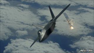 An F-22 drops a flare over Japan, in a 2009 handout photo