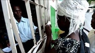 People collect rehydration medicine in Haiti