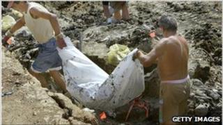 Workers remove human remains from a mass grave near Zvornik in 2003.