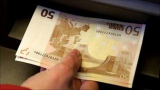 Euro notes being taken from a Berlin cashpoint - file pic