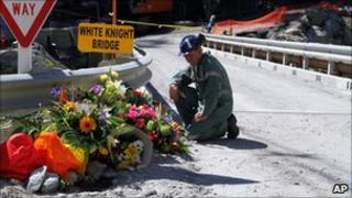 A miner lays flowers at the Pike River mine, where 29 miners died (29 November 2010)