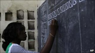 Election official write results on a blackboard