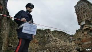 Policeman guards collapsed wall at Pompeii (! Dec 2010)