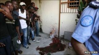 UN policeman near blood stains at RDR office