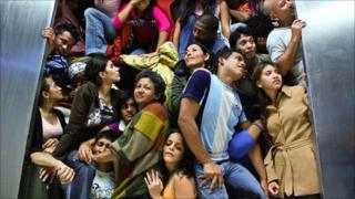 Prometeo Deportado still of people trying to squeeze out of the waiting room at the airport