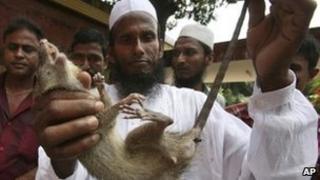 File photo of a Bangladeshi farmer with a dead rat