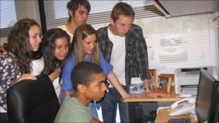 Uruguayan students check the stock market on their classroom computer